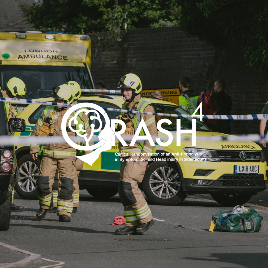 Emergency responders at the scene of a crash, with a police cordon and ambulance in the background.