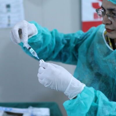A clinician in Pakistan prepares to administer tranexamic acid.