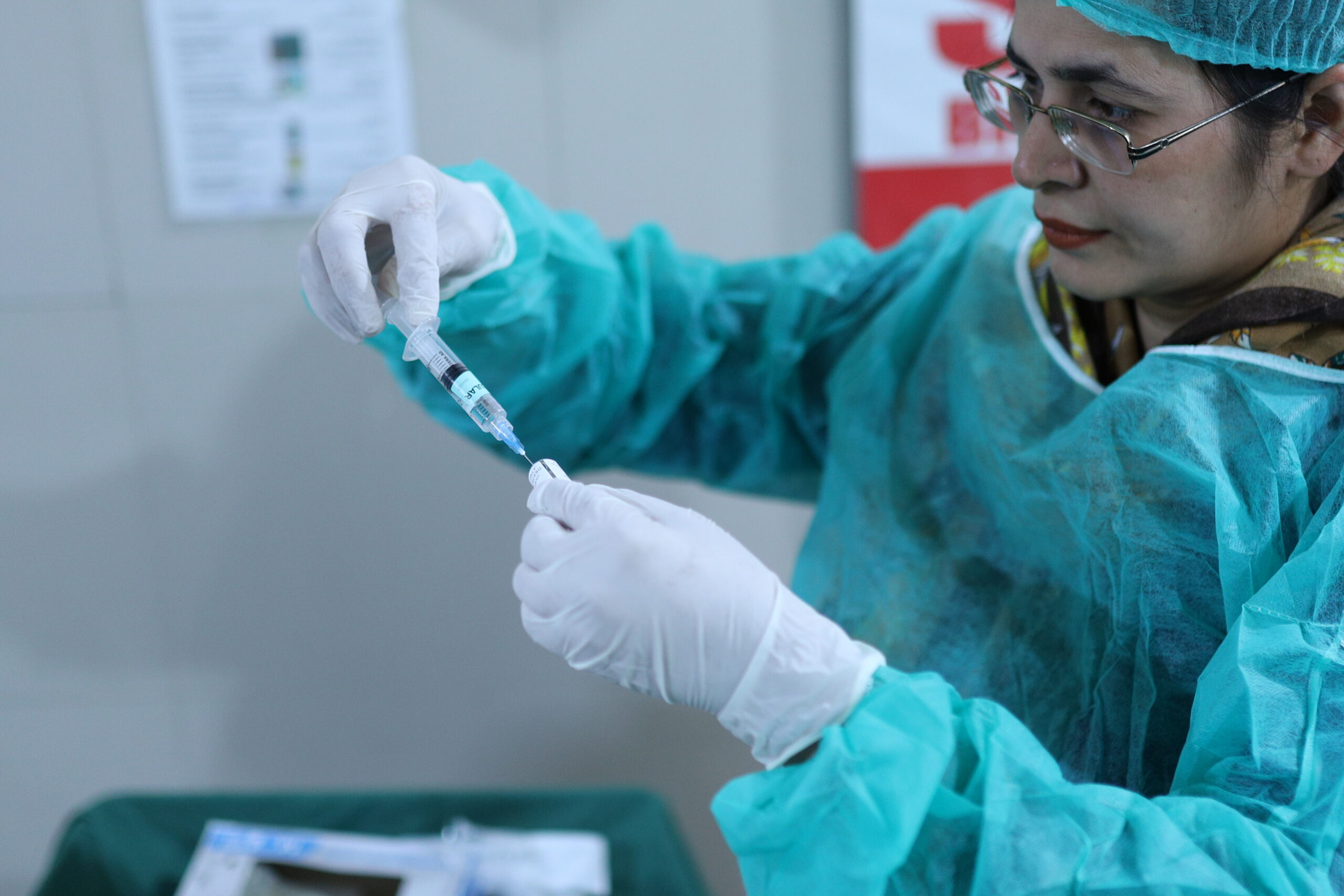 A clinician in Pakistan prepares to administer tranexamic acid.